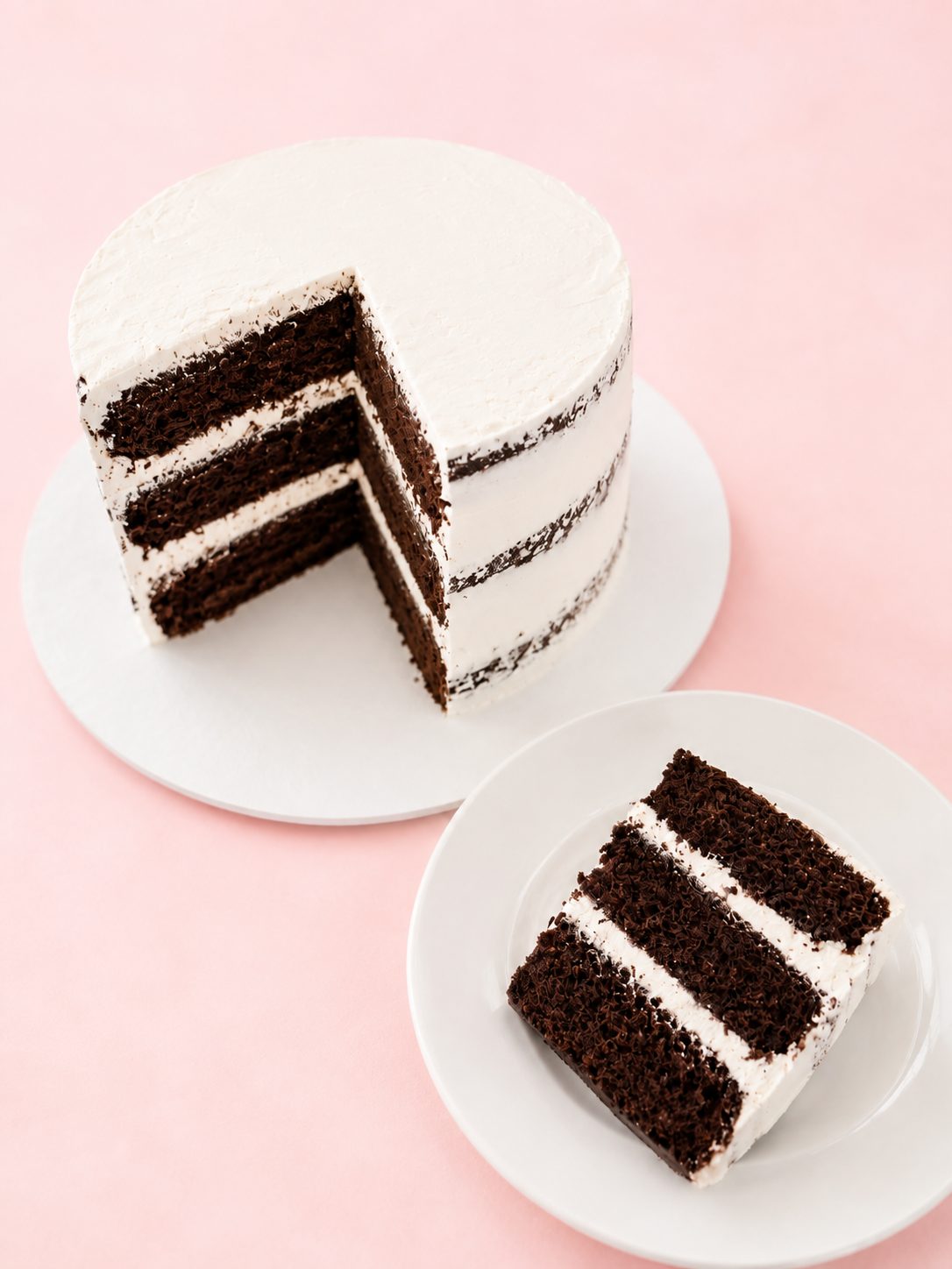 A chocolate layer cake with a cut slice showing the layers