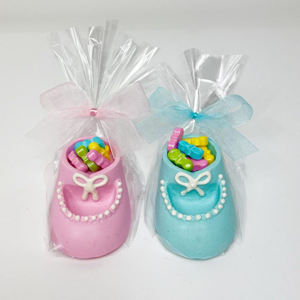 Pink and blue baby shoe cookies wrapped as baby shower favors