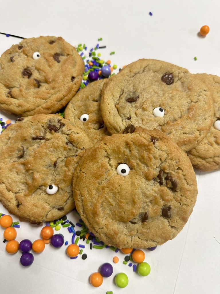 Chocolate chip cookies decorated with candy eyes and colored sweets