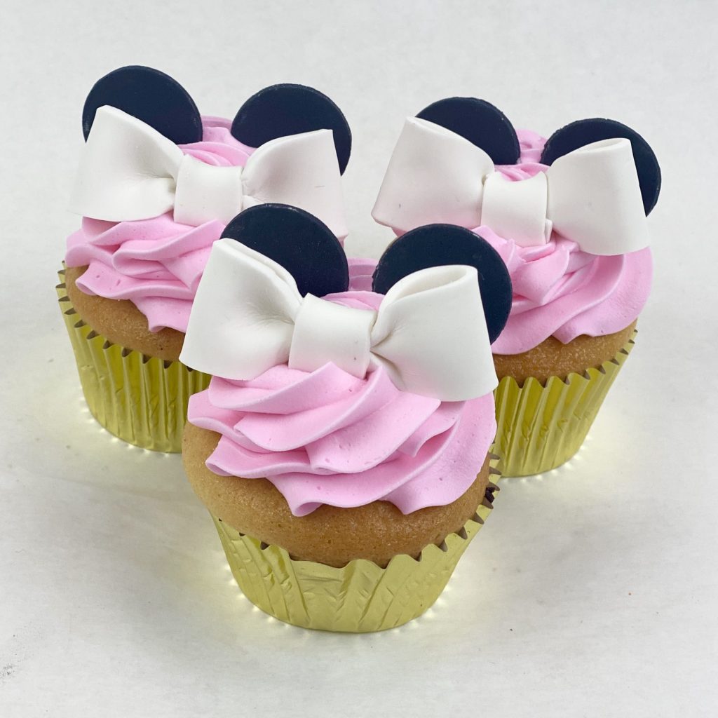 Character cupcakes with pink buttercream, fondant bows and ears