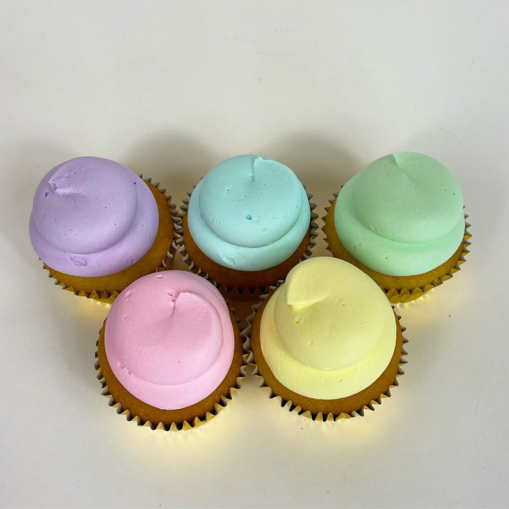 Cupcakes frosted in soft pastel lilac, mint, pink and yellow