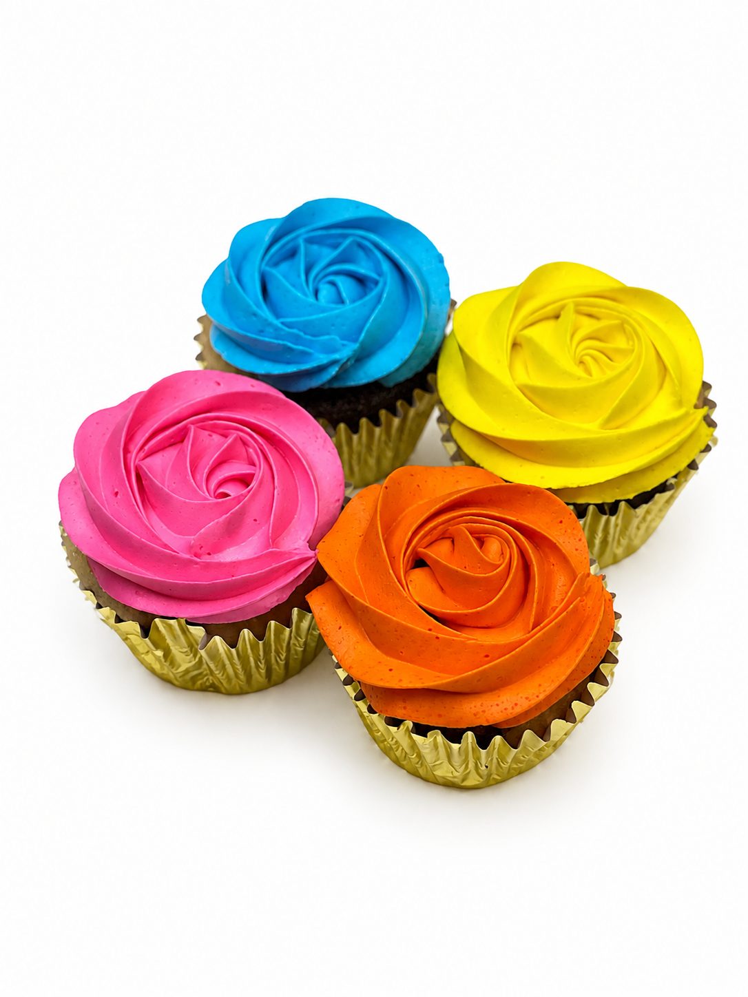 Cupcakes piped with rose swirls in bright blue, pink, yellow and orange