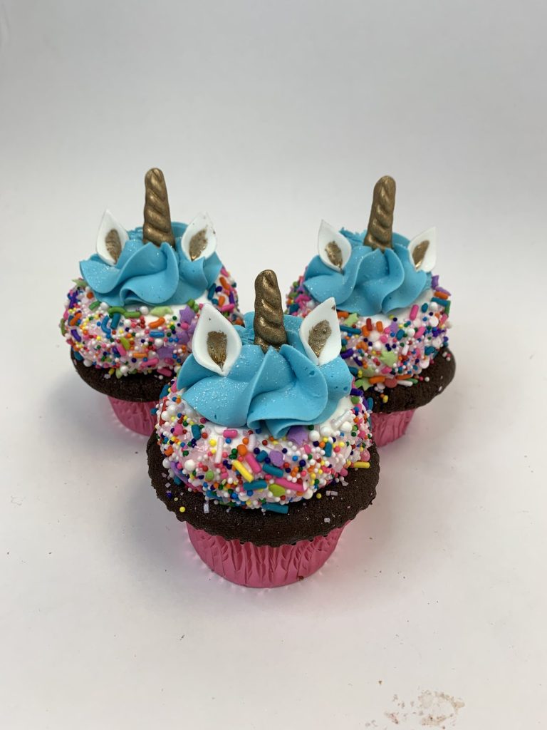 Unicorn cupcakes with sprinkle manes, sugar horns and ears