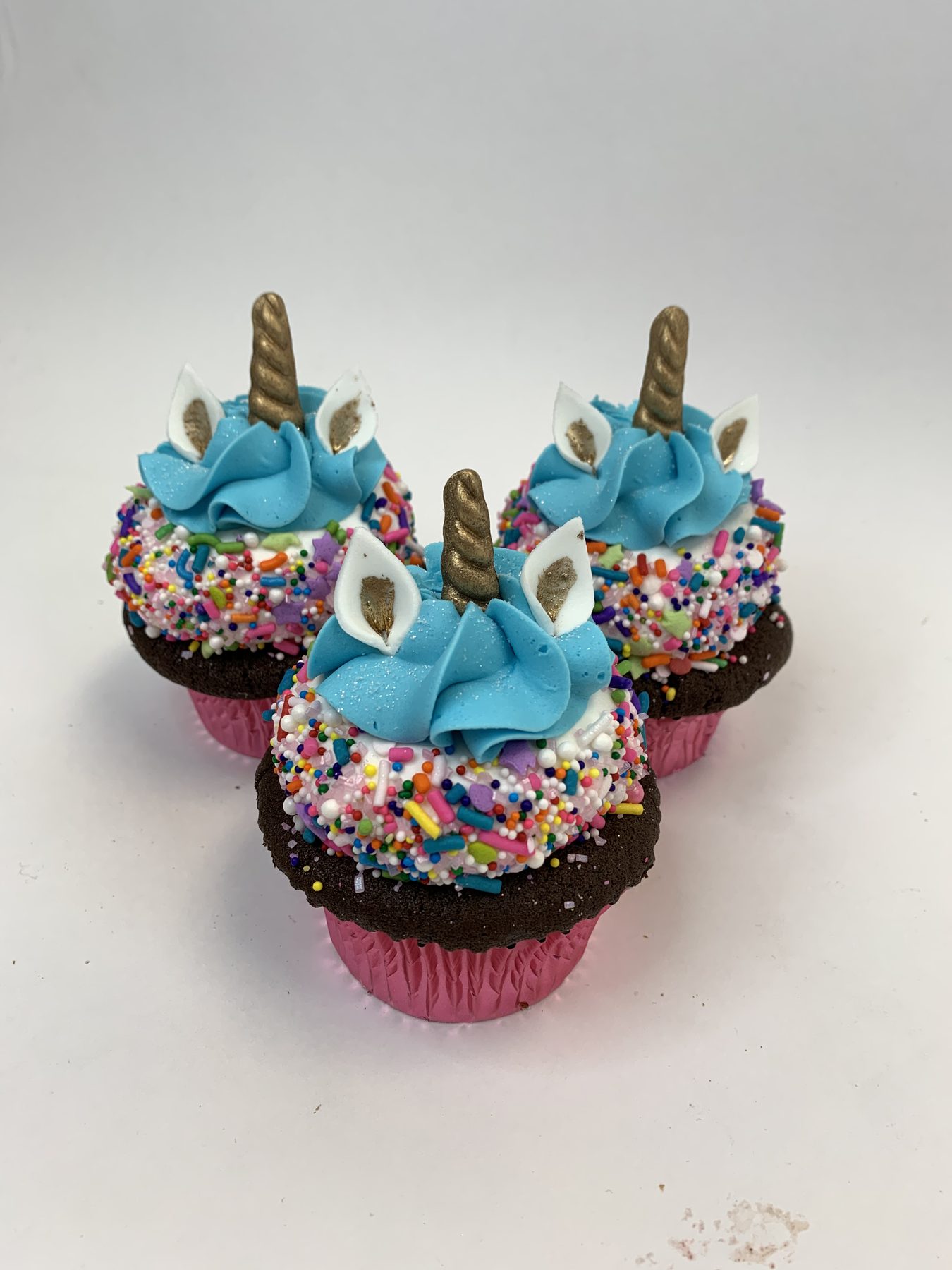 Unicorn cupcakes with sprinkle manes, sugar horns and ears