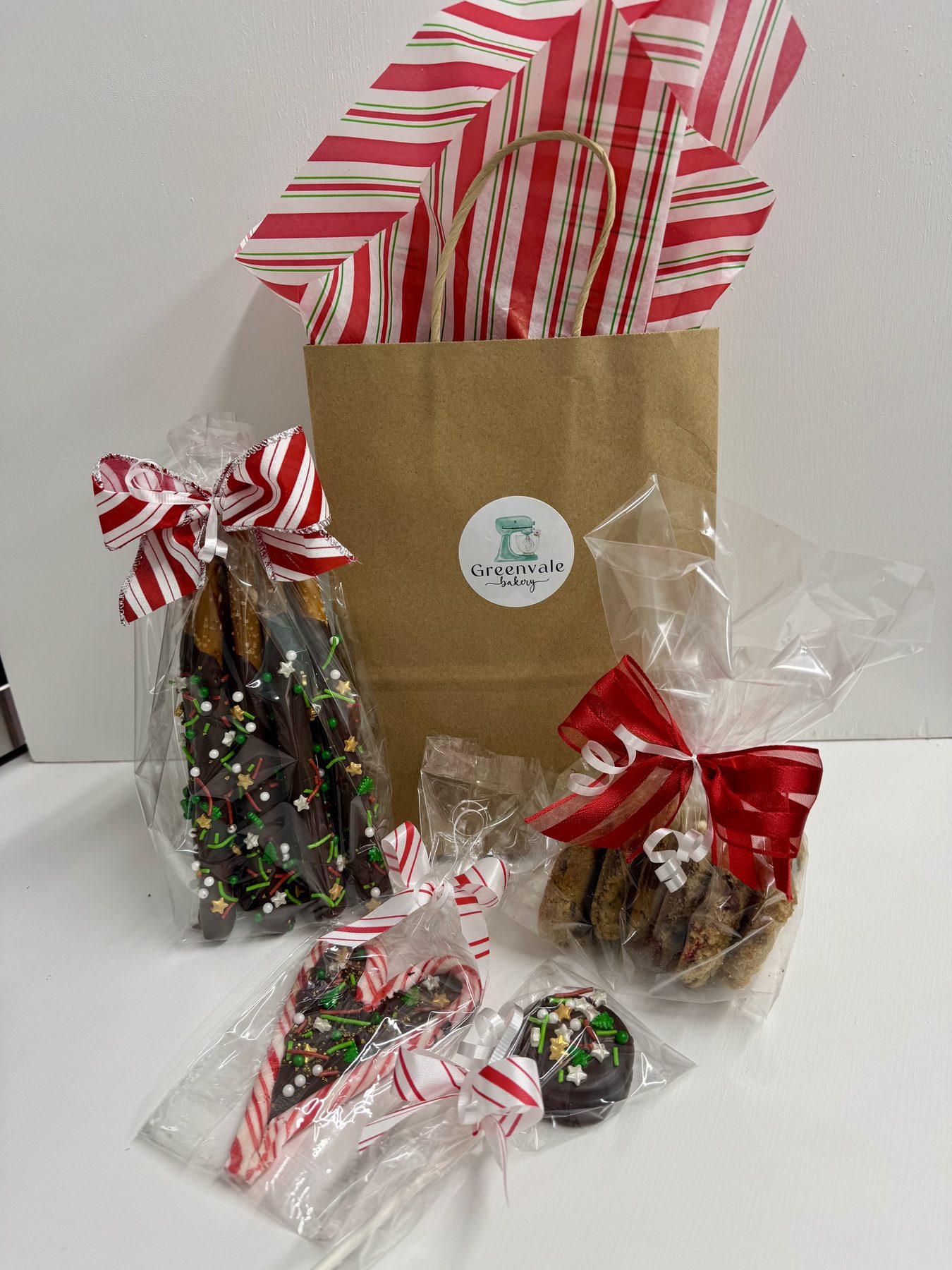 Holiday gift bags filled with ribbon-tied dipped pretzels