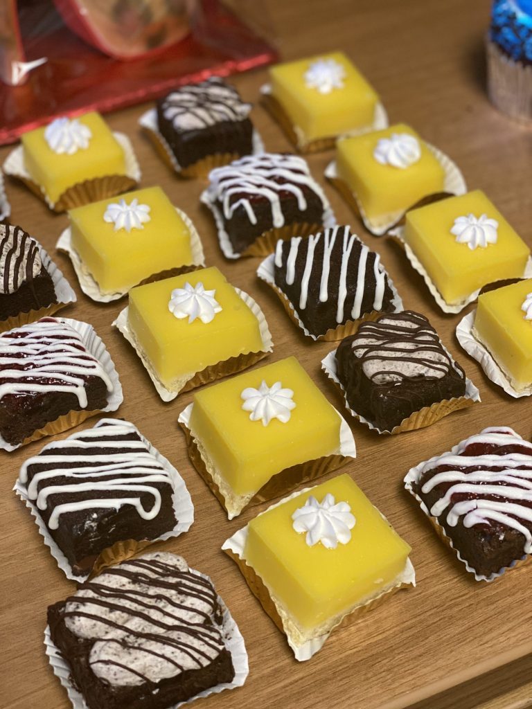 A tray of lemon and chocolate petit fours with piped detail