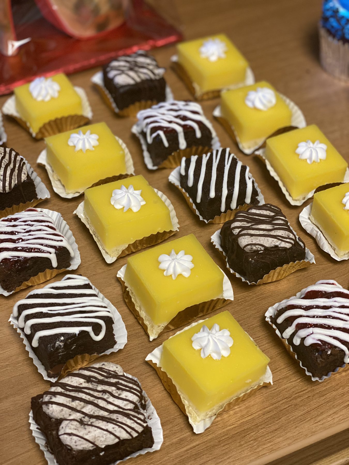 A tray of lemon and chocolate petit fours with piped detail